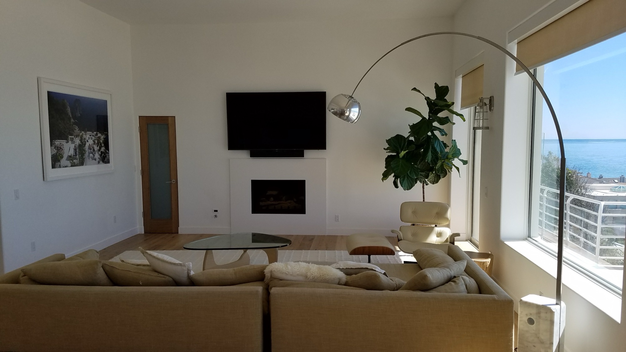 TV mounted flush inside a white built-in wall unit with no visible cords