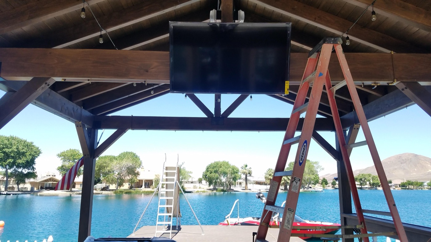 TV mounted under a covered lakeside gazebo